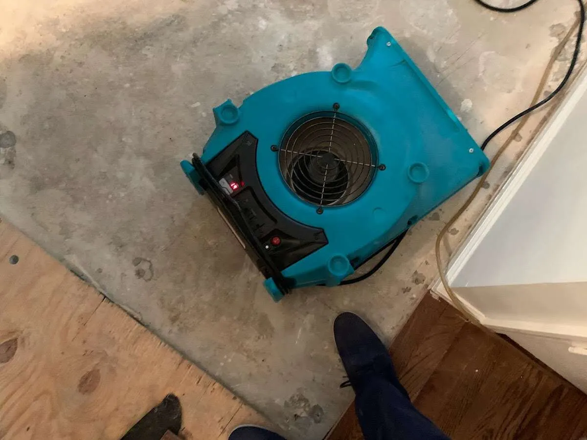 Air mover drying subfloor during Commercial Water Damage Restoration in Cinco Ranch